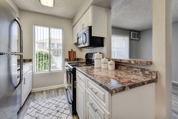Kitchen with stainless steel appliance package and LVT flooring